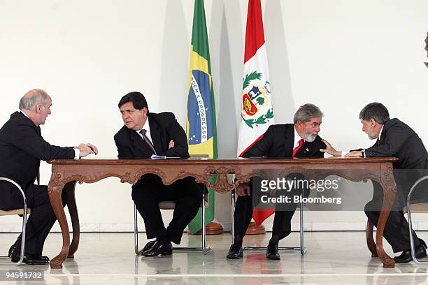 Brazilian President Luiz Inacio Lula da Silva, center right, speaks to Peruvian Foreign Minister Jose Antonio Garcia Belaunde and Peruvian President...