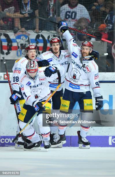Louis-Marc Aubry celebrates with teammates Jonas Mueller , Frank Hoerdler and Marcel Noebels of Berlin after scoring his teams fourth goal during the...