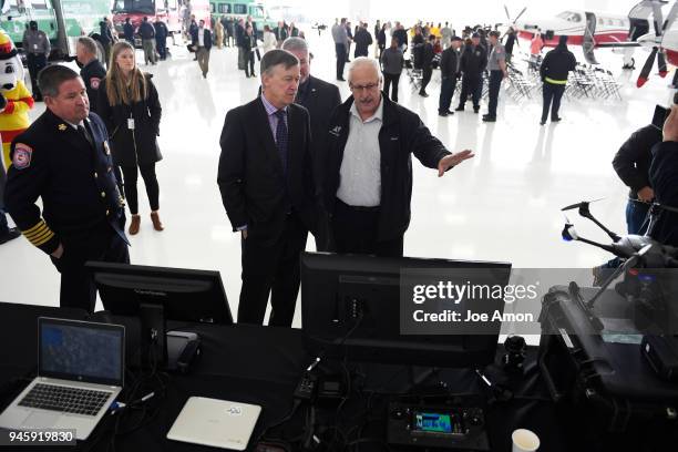 Governor John Hickenlooper listens as Robert Gann, PhD, Deputy Director, Center of Excellence for advanced technology aerial firefighting explains...