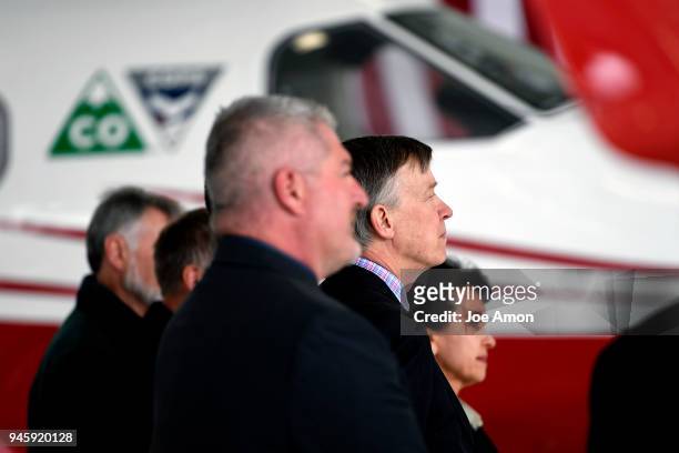 Governor John Hickenlooper listens during a press conference as the Director of the Colorado Department of Public Safety and the Director of the...