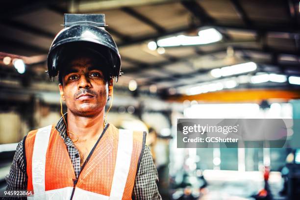 wearing a welder mask while looking at the camera - steel worker stock pictures, royalty-free photos & images