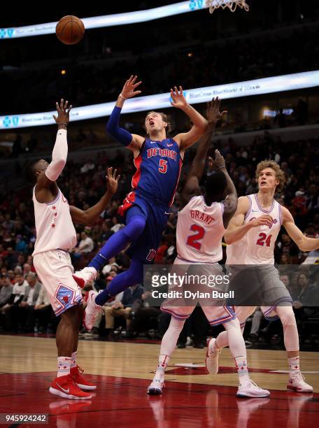 Luke Kennard of the Detroit Pistons loses control of the ball while being guarded by David Nwaba, Jerian Grant, and Lauri Markkanen of the Chicago...