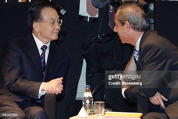 Wen Jiabao, premier of China, left, speaks with Lawrence Gonzi, prime minister of Malta, before the start of the ASEM 6 Summit in Helsinki, Finland,...