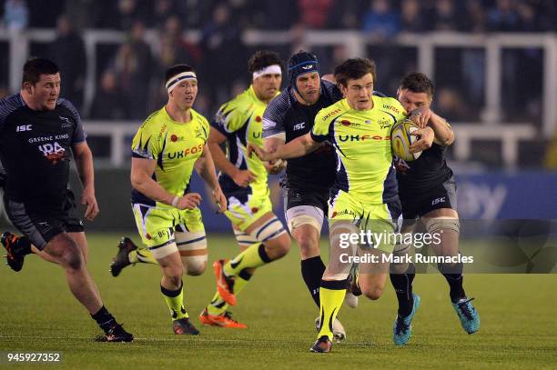 MacGinty of Sale Sharks is tackled by Will Welch and Scott Wilson of Newcastle Falcons during the Aviva Premiership match between Newcastle Falcons...