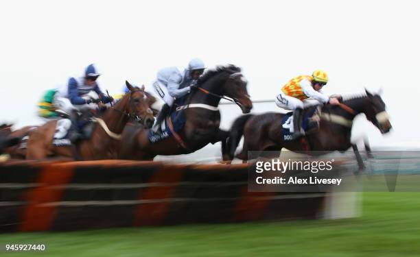 Dans Le Vent ridden by Gavin Sheehan and Santini ridden by Nico de Boinville clear a fence during the Doom Bar Sefton Novices' Hurdle Race on Ladies...