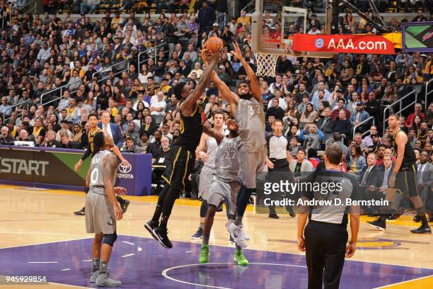 Karl-Anthony Towns of the Minnesota Timberwolves reaches for the ball while Julius Randle of the Los Angeles Lakers goes to the basket on April 6,...