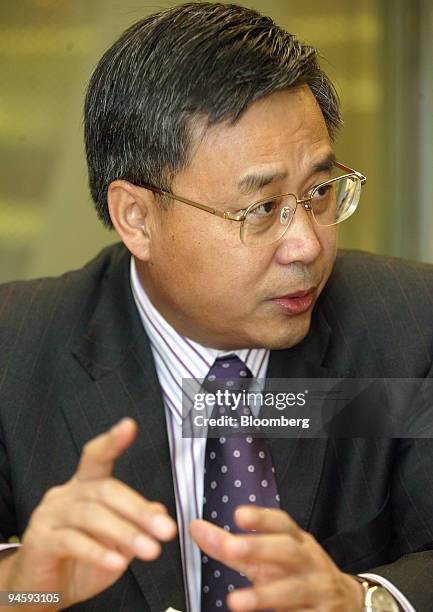 Guo Shuqing, chairman of China Construction Bank, gestures during an interview in Bloomberg's offices in Beijing, China, on Monday, September 11,...