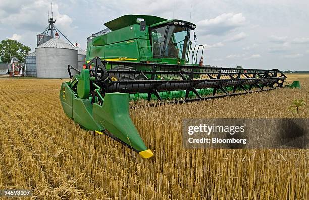Farmer runs a new combine through the first days harvest of more than 900 acres of winter wheat in a field near Delaware, Ohio, Friday, June 30,...