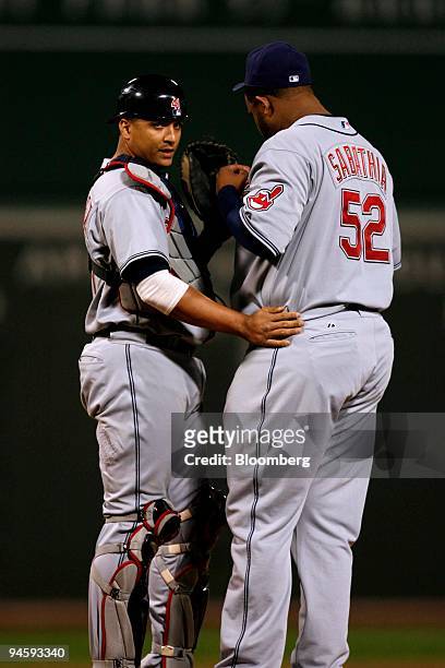 Sabathia of the Cleveland Indians, right, talks to catcher Victor Martinez during the first game against the Boston Red Sox in the American League...