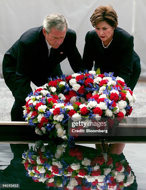 President George W. Bush, center, and first lady Laura Bush lay a wreath during a memorial event held at Ground Zero in New York on Sunday, September...