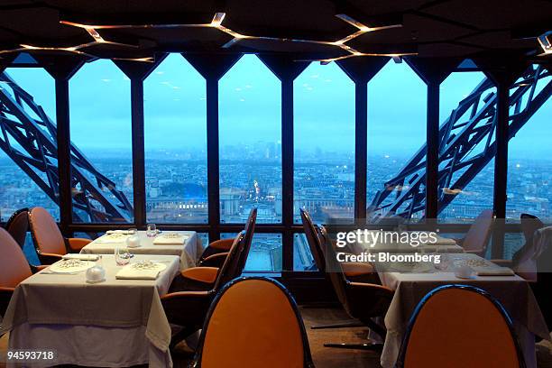 The Paris cityscape at dusk is viewed from the dining room of the Jules Verne Restaurant, on the second floor of the Eiffel Tower, in Paris, France,...