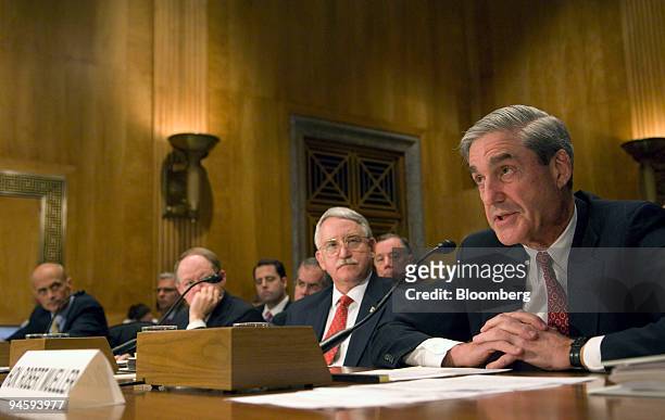 Director Robert Mueller, right, testifies at a Senate Committee on Homeland Security and Governmental Affairs hearing in Washington, D.C., Monday,...