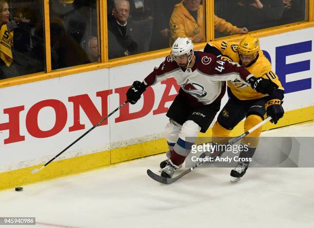 Colorado Avalanche defenseman Mark Barberio and Nashville Predators center Colton Sissons get after the puck in the first period during the first...