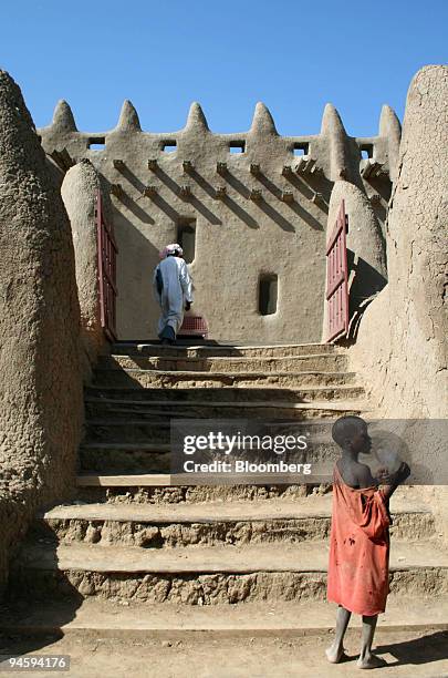 Child stands at the bottom of steps which lead up to the Grand Mosque in Djenne, Mali, on Thursday, Oct. 11, 2007. Mali is an extremely poor country,...