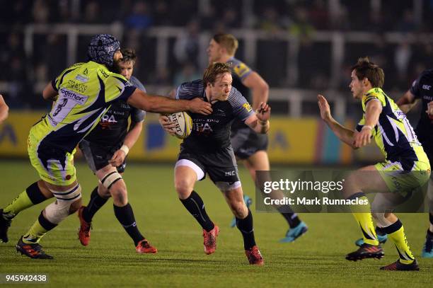 Josh Strauss of Sale Sharks tackles Joel Hodgson of Newcastle Falcons during the Aviva Premiership match between Newcastle Falcons and Sale Sharks at...