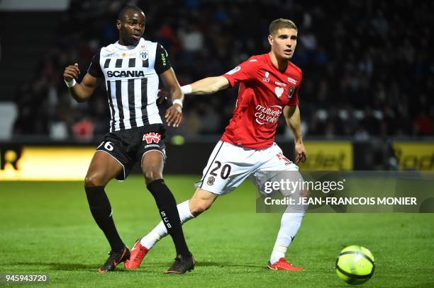 Angers' Congolese midfielder Prince Oniangue vies with Nice's French defender Maxime Le Marchand during the French L1 football match between Angers...