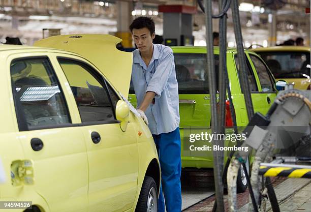 Worker assembles a Chery QQ compact car on an assembly line in the Chery Automotive Co. Ltd. Factory in Wuhu, Anhui Province, China, on Wednesday,...