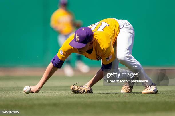 Tigers right handed pitcher Austin Bain fields a ball during a baseball game between the Mississippi State Bulldogs and the LSU Tigers on March 31,...