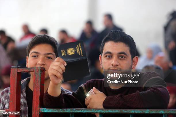 Dozens of Palestinians wait in the Abu Yousef al-Najjar Hall in the southern Gaza Strip town of Khan Yunis to travel to Egypt via the temporarily...