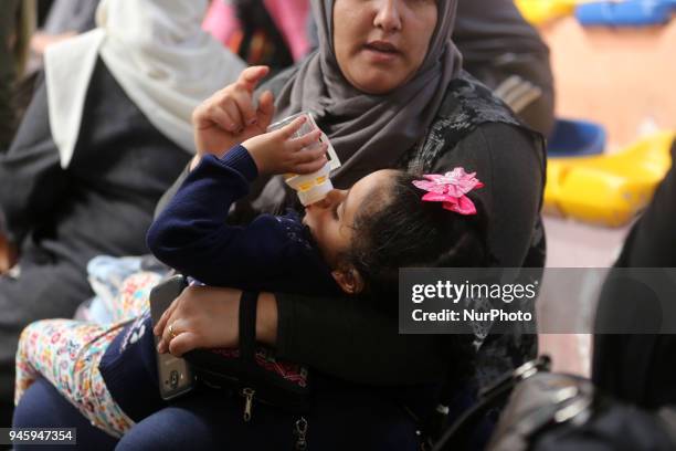 Dozens of Palestinians wait in the Abu Yousef al-Najjar Hall in the southern Gaza Strip town of Khan Yunis to travel to Egypt via the temporarily...