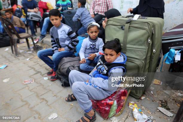 Dozens of Palestinians wait in the Abu Yousef al-Najjar Hall in the southern Gaza Strip town of Khan Yunis to travel to Egypt via the temporarily...