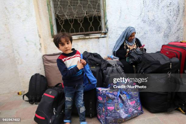 Dozens of Palestinians wait in the Abu Yousef al-Najjar Hall in the southern Gaza Strip town of Khan Yunis to travel to Egypt via the temporarily...