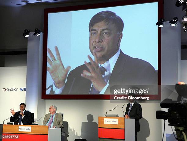 Mittal Steel Co. Chairman Lakshmi Mittal, on screen and left, speaks while Arcelor Chairman of the Board of Directors Joseph Kinsch, center, and...
