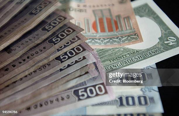 Piles of Taka, the currency of Bangladesh, are displayed for a photograph in Dhaka, Bangladesh, on Thursday, Jan. 25, 2007.