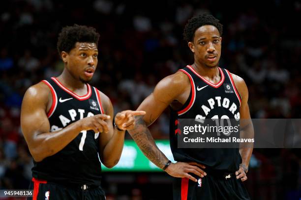 DeMar DeRozan and Kyle Lowry of the Toronto Raptors look on against the Miami Heat during the second half at American Airlines Arena on April 11,...