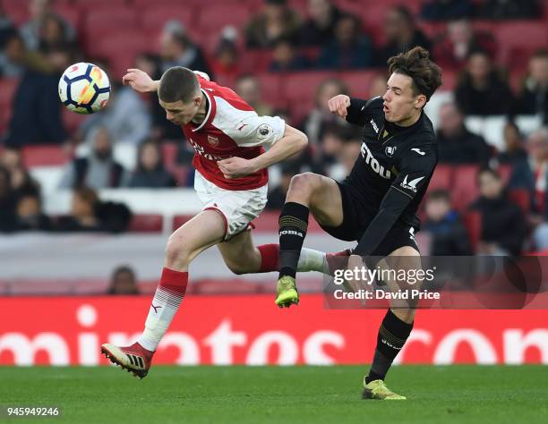 Charlie Gilmour of Arsenal is challenged by Jack Evans of Swansea during the match between Arsenal U23 and Swansea U23 at Emirates Stadium on April...