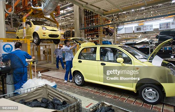 Workers assemble a Chery QQ compact car on the assembly line in the Chery Automotive Co. Ltd. Factory in Wuhu, China, on Wednesday, May 16, 2007....