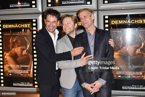 Oliver Mommsen, producer Adrian Topol and director Thomas Stiller during the premiere 'Die Haut der Anderen' at Kino in der Kulturbrauerei on April...