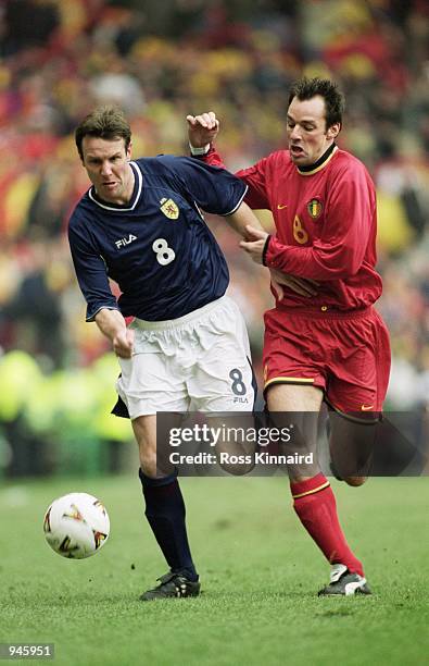 Craig Burley of Scotland holds off the challenge from Bart Goor of Belgium during the World Cup 2002 Group Six Qualifying match played at Hampden...