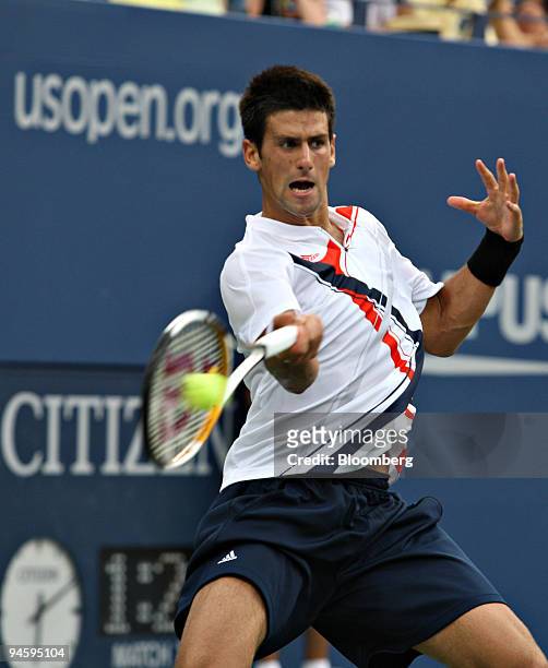 Novak Djokovic of Serbia returns to Roger Federer of Switzerland during their men's singles final match on day fourteen of the U.S. Open at the...
