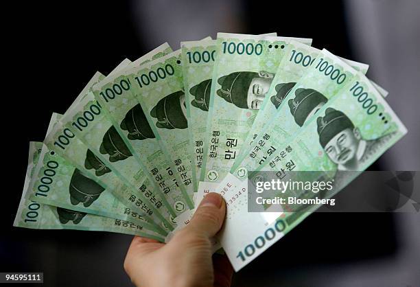 South Korean won bills are displayed for a photograph in Seoul, South Korea, on Sunday, Sept. 9, 2007. Asian currencies dropped, led by South Korea's...