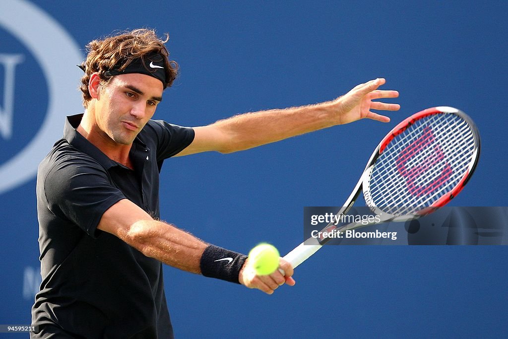 Roger Federer of Switzerland returns to Novak Djokovic of Se