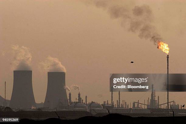 Cooling towers emit steam at the Sasol Secunda plant in the eastern highlands of Mpumalanga province, South Africa, on Sunday, Sept. 9, 2007. Sasol...