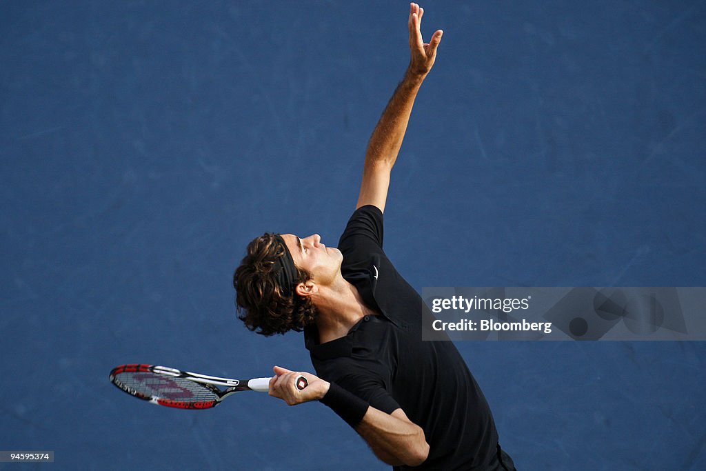 Roger Federer of Switzerland serves to Novak Djokovic of Ser