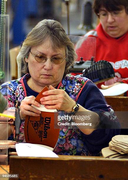 Senior Sewer Kay Baughman prepares a football for sewing inside a Wilson Sporting Goods Company facility in Ada, Ohio, U.S., on Wednesday, Jan. 16,...