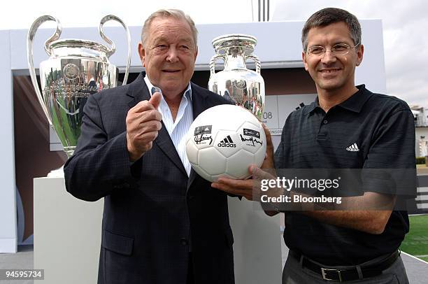 Union of European Football Associations or UEFA President Lennart Johansson, left, and Adidas AG Chief Executive Herbert Hainer pose in front of UEFA...
