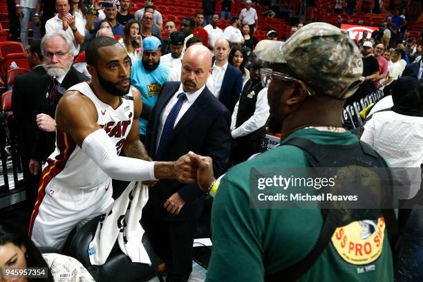 Wayne Ellington of the Miami Heat shakes hands with Denver Broncos linebacker Von Miller after the game against the Toronto Raptors at American...