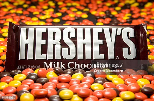 Hershey's Milk Chocolate Bar is arranged among Reese's Pieces, also a Hershey product, for an illustration in Cambridge, Massachusetts, Wednesday,...