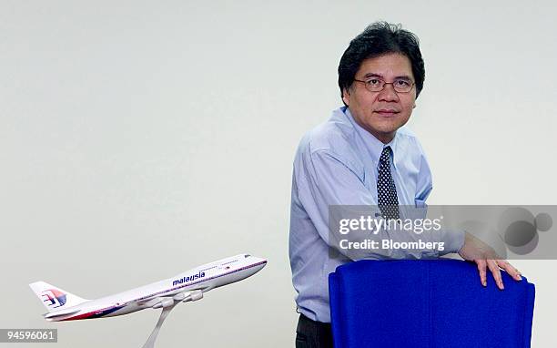 Malaysian Airline System Bhd. Chief Executive Officer Idris Jala poses with a Malaysian Airline plane model at his office in Subang, Malaysia, on...