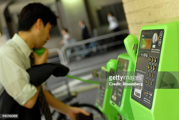 Man uses a NTT Docomo payphone in Tokyo, Japan, Wednesday, June 28, 2006. NTT Docomo holds their annual shareholders' meeting today.