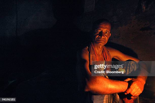 Year-old Bhagwat Yadav, a rickshaw puller for past 20 years, sits in his house, which hasn't had electricity for the last 3 years, in Kolkata, India,...