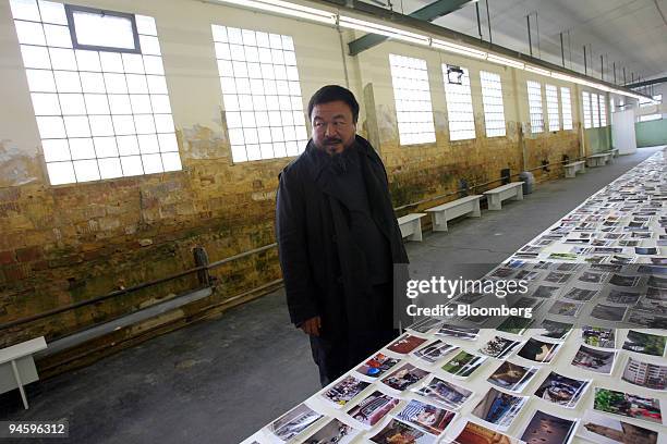 Chinese Artist Ai Weiwei pauses while looking at photographs taken by some of the 1001 Chinese citizens brought from China to participate in the...