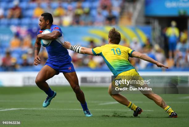 Tomasi Alosio Logotuli of Samoa makes a break past Ben O'Donnell of Australia during Rugby Sevens Men's Pool B match between Australia and Samoa on...
