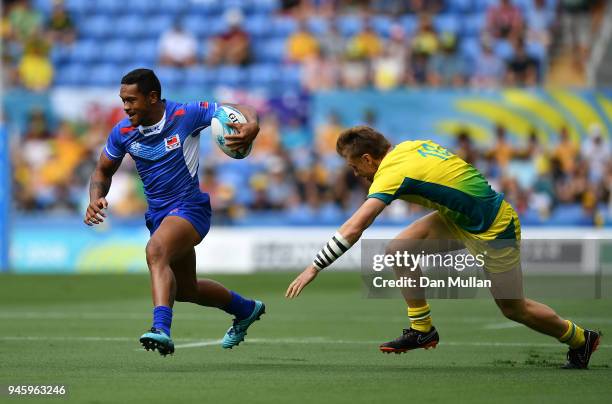 Tomasi Alosio Logotuli of Samoa makes a break past Ben O'Donnell of Australia during Rugby Sevens Men's Pool B match between Australia and Samoa on...