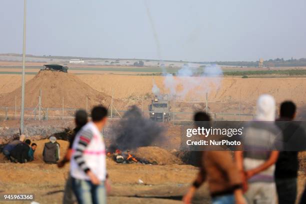 Palestinians protesters during clashes with Israeli topps near the border with Israel in the east of Gaza City on, 13 April 2018. According to local...