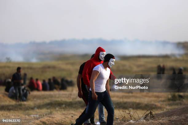 Palestinians protesters during clashes with Israeli topps near the border with Israel in the east of Gaza City on, 13 April 2018. According to local...